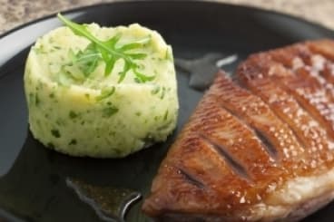 Magret de canard rôti et laqué au miel épicé, purée au pistou de roquette