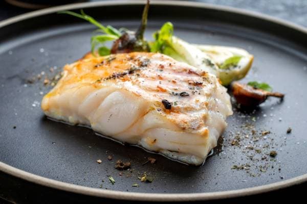 Cabillaud en croûte d'herbes, lentilles et yaourt épicé