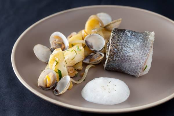 Filet de bar au poivre d'ailleurs, panais rôti au beurre 1-2 sel et noisettes, marinière de coques